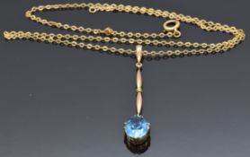 A 9ct gold pendant set with a blue topaz on a 9ct gold chain, 2.5g