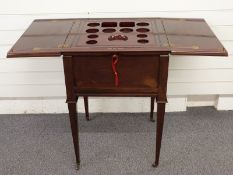 Drinks cabinet with fold out top opening to reveal a rising decanter and glass platform, raised on