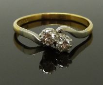 An 18ct gold ring set with two diamonds in a platinum setting, size Q, 2.46g