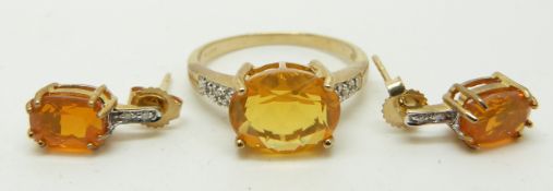 A 9ct gold ring set with an oval cut fire opal and diamonds and a pair of similar earrings, 3.6g,