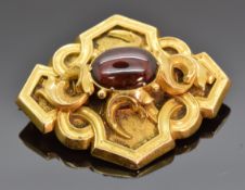 Victorian yellow metal brooch set with a garnet cabochon, 6.6g, 2.8 x 3.5cm