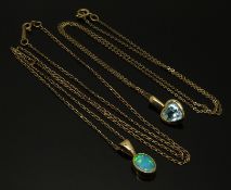 A 9ct gold pendant set with a heart shaped aquamarine and a 9ct gold pendant set with an opal,