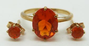 A 9ct gold ring set with an oval cut Mexican fire opal (size L/M) and a pair of earrings set with