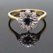 An 18ct gold ring set with a sapphire and diamonds in a flower setting, size P, 3.1g