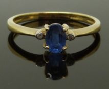 A 9ct gold ring set with an oval cut sapphire and diamonds, size N, 1.63g