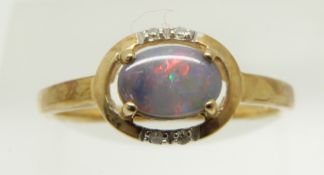 A 9ct gold ring set with an oval black opal cabochon and diamonds, 1.6g, size N