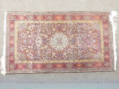 Kashmiri woollen rug with white geometric rosette design on deep blue ground, 166cm x 90cm