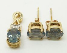 A 9ct gold pendant set with an oval cut blue fire opal and diamonds and a pair of similar