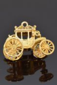 A 9ct gold pendant/charm in the form of a carriage, 5.6g