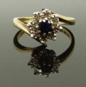 A 9ct gold ring set with a sapphire and diamonds, size L/M, 3.44g