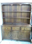 An oak three drawer dresser with plate rack above, W149 x D49 x H190cm
