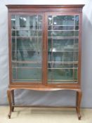 19thC glazed two door display cabinet with adjustable shelves, raised on cabriole legs, W127 x D37 x