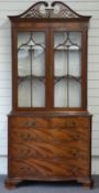 Georgian style glazed display cabinet with two over three graduated serpentine drawers, by repute