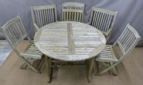 Teak extending garden table and six chairs (four being folding examples), minimum length of table
