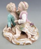Meissen figure of sweethearts embracing, with applied grape and vine decoration, blue crossed swords
