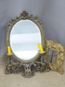 Ornate metal and bevelled glass mirror with integral candle sconces, height 58cm, and a gilt metal