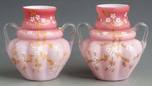 A pair of Thomas Webb pink quilted satin glass vases with gilt decoration and applied clear handles,