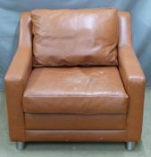 Brown leather armchair raised on brushed stainless steel or similar legs