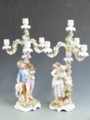 A pair of 19thC German figural candelabra with a monkey and parrot on the figures' shoulders, H 53cm