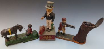 Three vintage novelty cast iron money boxes comprising 'Uncle Sam Bank', 'Teddy and the Bear' and