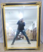 A large over mantel mirror with black and gilt frame, overall size 110 x 140cm
