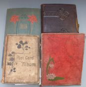A large collection of postcards in three albums, Edwardian onwards and a tooled leather Carte