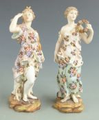 A pair of late 19th/20thC Volkstedt porcelain figurines carrying a garland and a bow and quiver