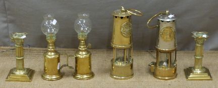 Two Eccles miner's lamps, a pair of brass candlesticks and French oil lamps, tallest 25cm