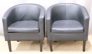 Two faux leather tub chairs raised on square tapering black legs