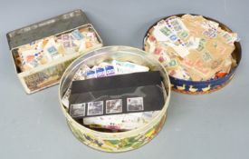 A tin of mint GB QEII stamps, singles and blocks and two tins of Canadian stamps