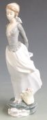 Lladro figure of a girl with basket of flowers at her feet, H 35cm