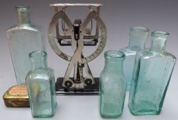 Quantity of glass bottles including Scott's, Dinneford's and Foster Clark, and a set of postage