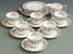 Shelley part tea set comprising six trios, milk and cake plate all decorated with vines, shape no