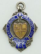 A hallmarked silver fob set with enamel reading 'Marylebone & Paddington District' verso engraved '