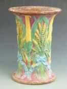 A 19thC Majolica garden seat with sheaves of wheat, corn and basket weave decoration, probably