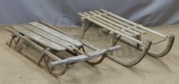Two vintage sledges, one by Harrods, length 103cm