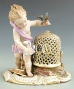Meissen figure of a boy with birds, blue crossed swords, mark to base, H 12cm