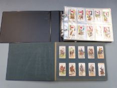 Two albums of cigarette cards to include Player's riders of the world, Ogden's British birds, Alpine