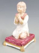 Bloor Derby figurine of a girl praying, raised on a tasselled plinth, H 9.5cm