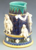 A large 19thC majolica jug or pitcher with applied figural decoration of courting couples drinking