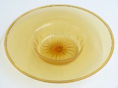 A large amber glass dish with folded rim engraved to the base Baccarat, 41cm in diameter.