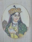 A 19thC Indian ivory portrait miniature of a lady with headdress, 8 x 6cm, in period frame