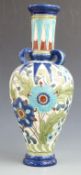 Burmantofts tube lined three handled pedestal vase decorated with flowers and foliage, impressed