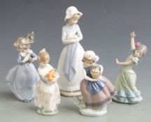 Nao figurine of a girl holding a puppy and four Lladro child figures, tallest 25cm