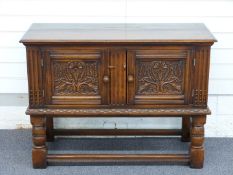 A carved oak two door cabinet/ small sideboard, W107 x D45 x H78cm
