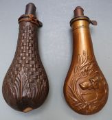 Two copper and brass powder flasks, one G Roe with embossed scene featuring a dog to both sides (