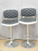 A pair of contemporary bar or kitchen counter adjustable stools with quilted leather effect