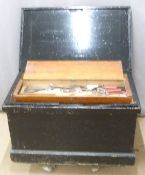 A 19th/20thC painted pine tool chest and contents with fitted interior and four drop handles.