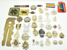 Small collection of British Army metal and anodised badges including Royal Anglican, Royal Irish