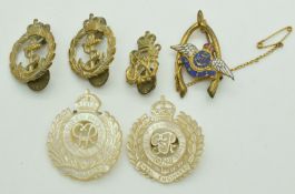 Two mother of pearl Royal Engineers brooches and three Royal Navy badges
